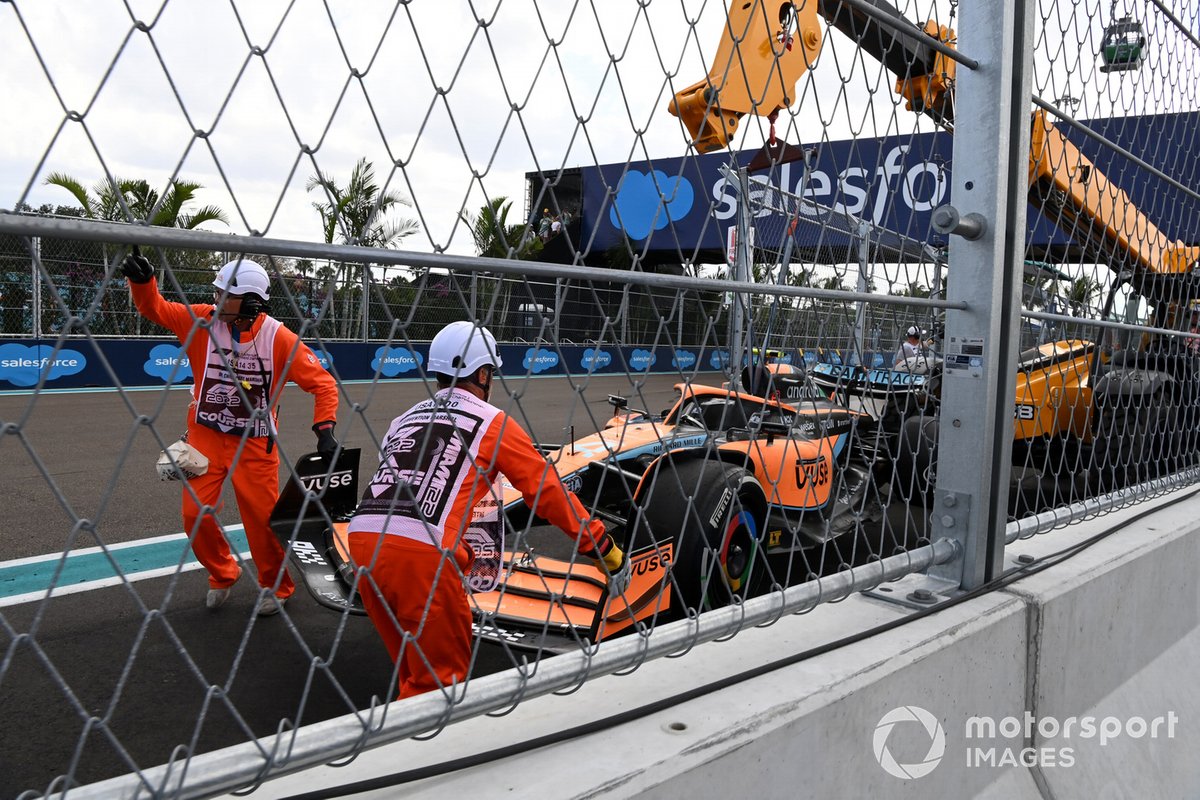 Marshals remove the damaged car of Lando Norris, McLaren MCL36, from the circuit