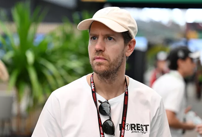 Sebastian Vettel arrives in the Paddock