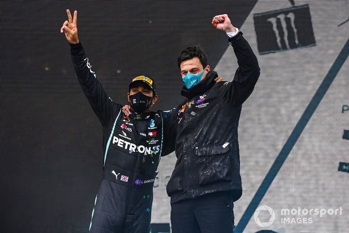 Lewis Hamilton, Mercedes-AMG F1, 1st position, and Toto Wolff, Executive Director (Business), Mercedes AMG, celebrate on the podium after securing a seventh world drivers title, on the podium