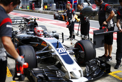 Kevin Magnussen, Haas F1 Team VF-17, stops in his pit as a Renault Sport F1 Team passes by