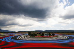 Kimi Raikkonen, Ferrari SF71H, leads Valtteri Bottas, Mercedes AMG F1 W09, and Kevin Magnussen, Haas F1 Team VF-18, under a cloudy sky