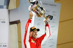 Sebastian Vettel, Ferrari, 1st position, lifts his trophy on the podium