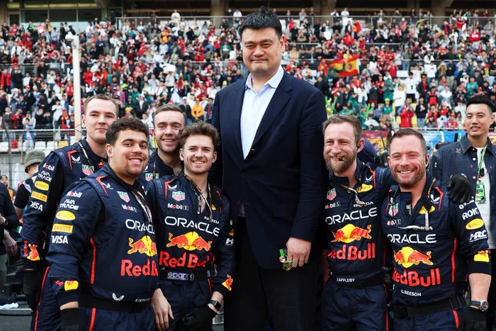 Yao Ming on the grid with Red Bull Racing team members