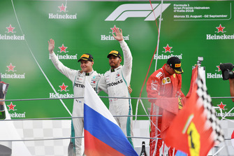 Valtteri Bottas, Mercedes AMG F1 and Lewis Hamilton, Mercedes AMG F1 celebrate on the podium and Kimi Raikkonen, Ferrari with Ferrari flag