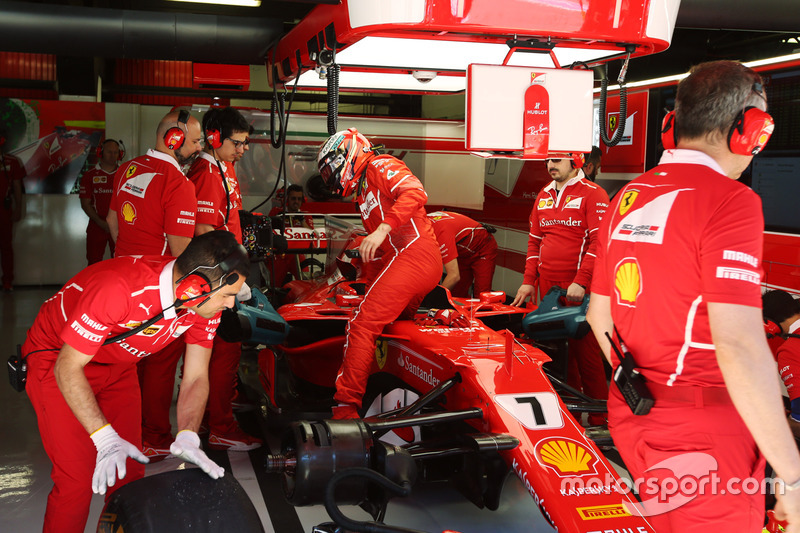 Kimi Raikkonen, Ferrari, climbs out of his car in the garage