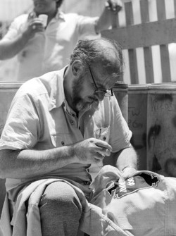 Don Nichols, Shadow Team Owner sews new logos onto his drivers' overalls