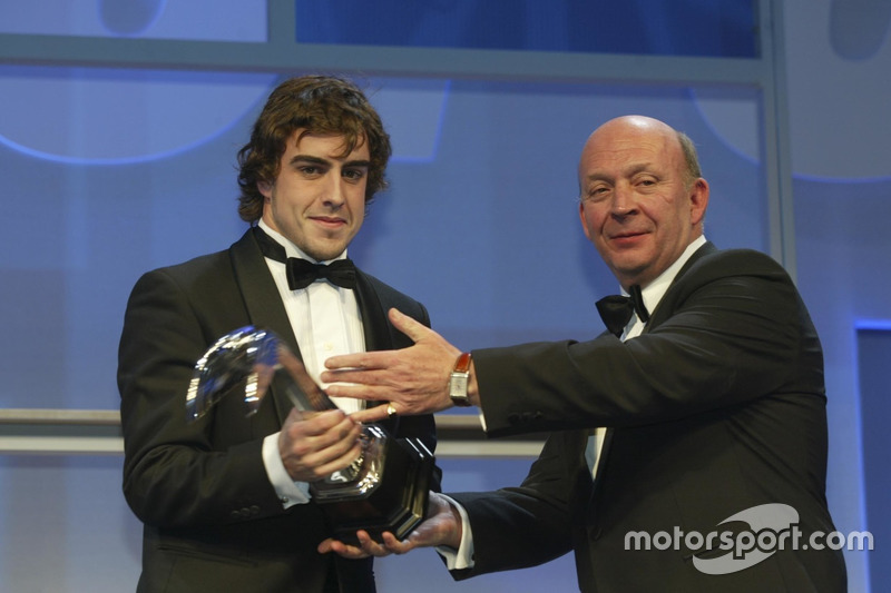 Fernando Alonso is handed the Gregor Grant Award by Nigel Roebuck