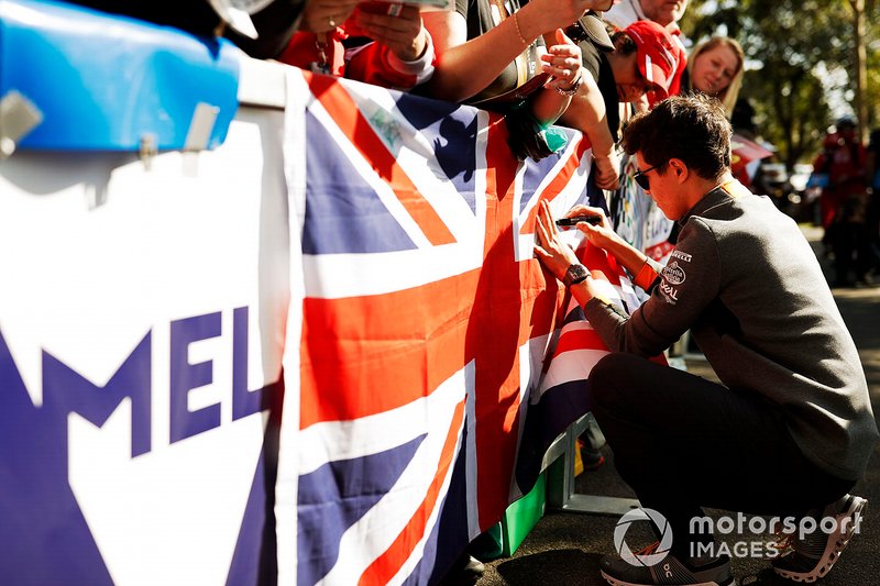 Lando Norris, McLaren, signs a Union Jack UK flag