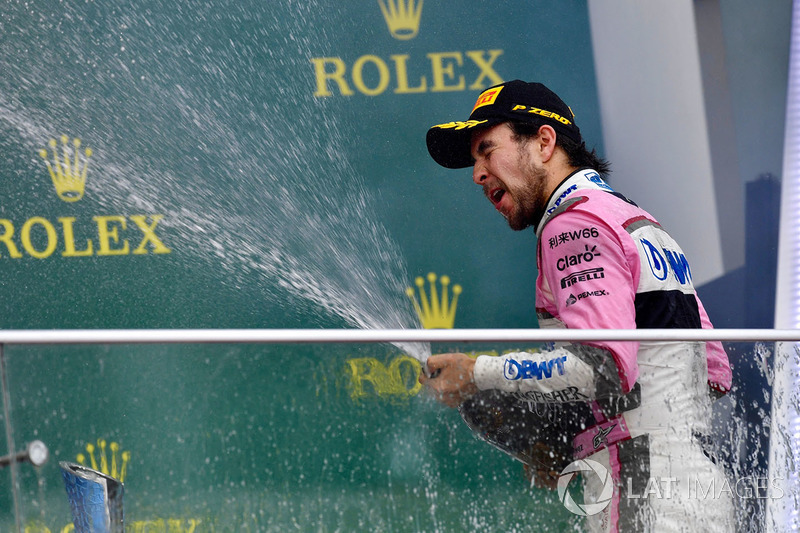 Third place Sergio Perez, Force India celebrates on the podium with the champagne