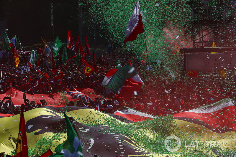 Confetti falls around the huge crowd of Ferrari fans gathered for the podium ceremony