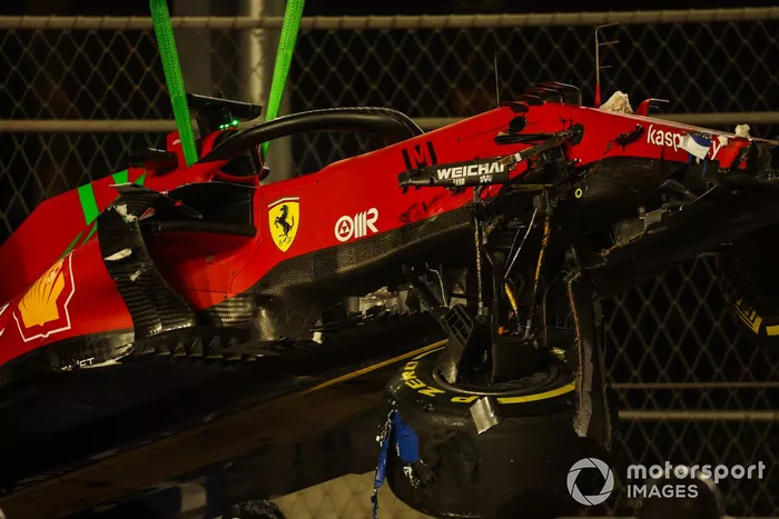 Los oficiales de pista retiran el coche de Charles Leclerc, Ferrari SF21, del circuito