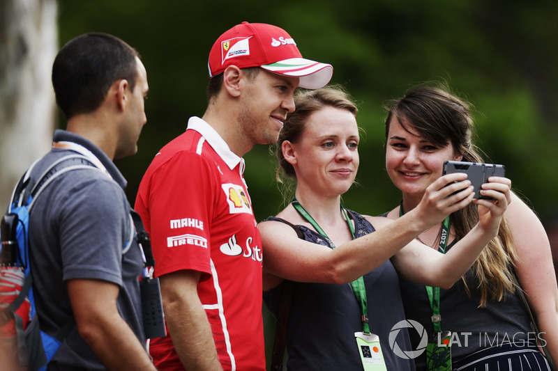 Sebastian Vettel, Ferrari, poses for a photo with a fans