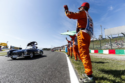 Marshals line the track as Lewis Hamilton, Mercedes AMG F1, passes in the drivers parade
