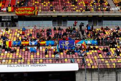 Fans in the pit straight grandstand wait during a weather delay in FP2