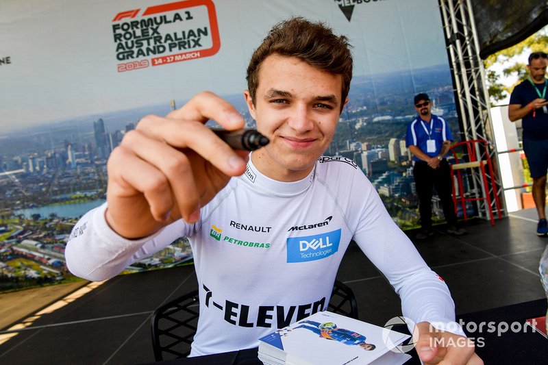 Lando Norris, McLaren, signs autographs