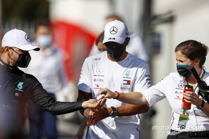 Lewis Hamilton, Mercedes-AMG F1, y Valtteri Bottas, Mercedes-AMG F1, se desinfectan las manos