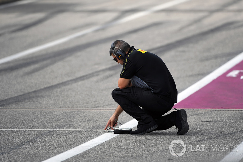 Pirelli engineer checks the track temperature