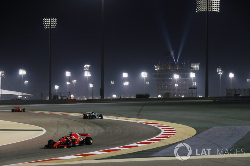 Sebastian Vettel, Ferrari SF71H, leads Valtteri Bottas, Mercedes AMG F1 W09, and Kimi Raikkonen, Fer