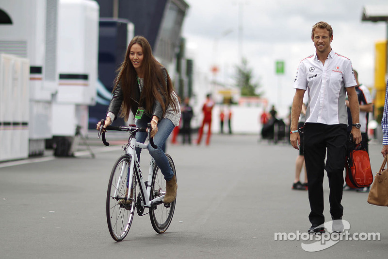 Jessica Michibata, rides a bicycle alongside boyfriend Jenson Button, McLaren