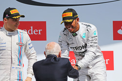 Race winner Lewis Hamilton, Mercedes AMG F1 celebrates on the podium with John Surtees