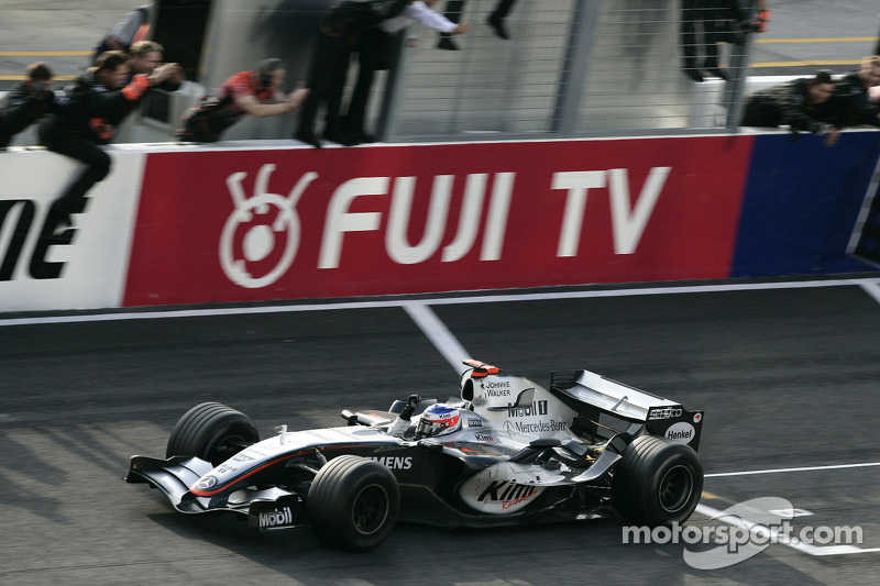 Race winner Kimi Raikkonen celebrates