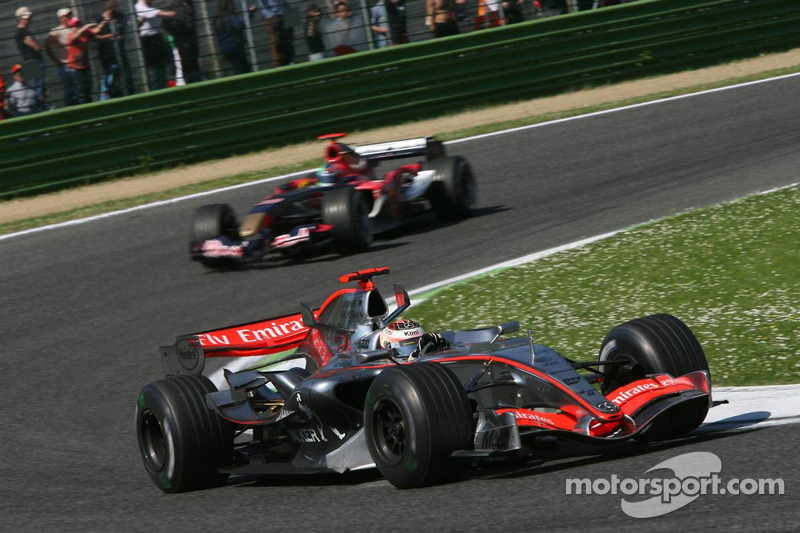 Kimi Raikkonen leads Scott Speed