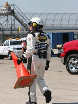 A NASCAR offical replaces the orange cone run over by Todd Kluever