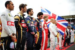 Pastor Maldonado, Lotus F1 Team and Romain Grosjean, Lotus F1 Team as the grid observes the national anthem