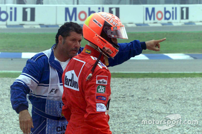 Michael Schumacher, Ferrari returns to the pits after crashing at the start