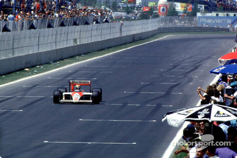 Ayrton Senna takes the checkered flag