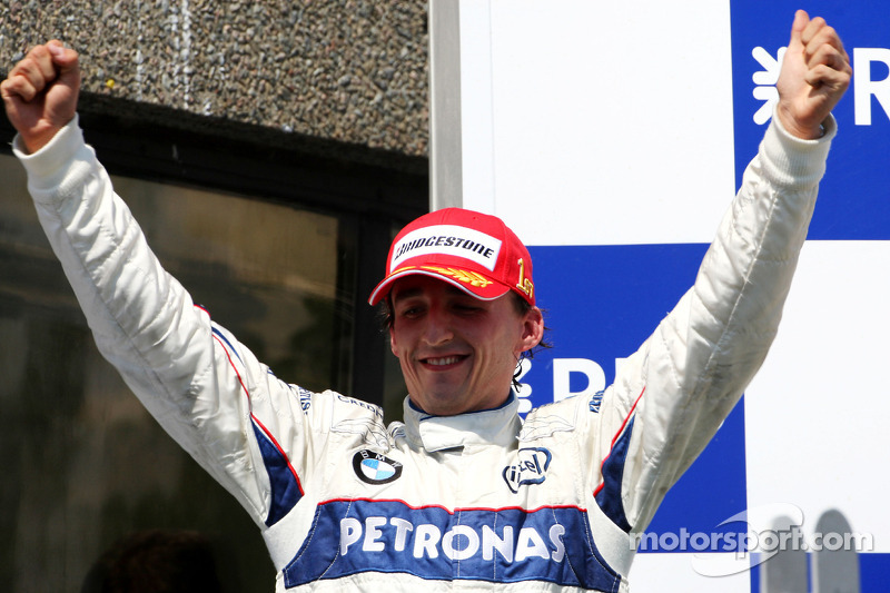 Podium: race winner Robert Kubica celebrates