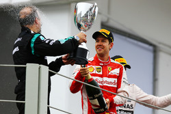 Sebastian Vettel, Ferrari celebrates his third position with Jimmy Waddell, Mercedes AMG F1 Composite Inspector on the podium